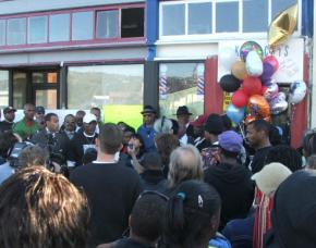 Hundreds of people gathered in front of an Oakland, Calif., barber shop owned by a victim of the police